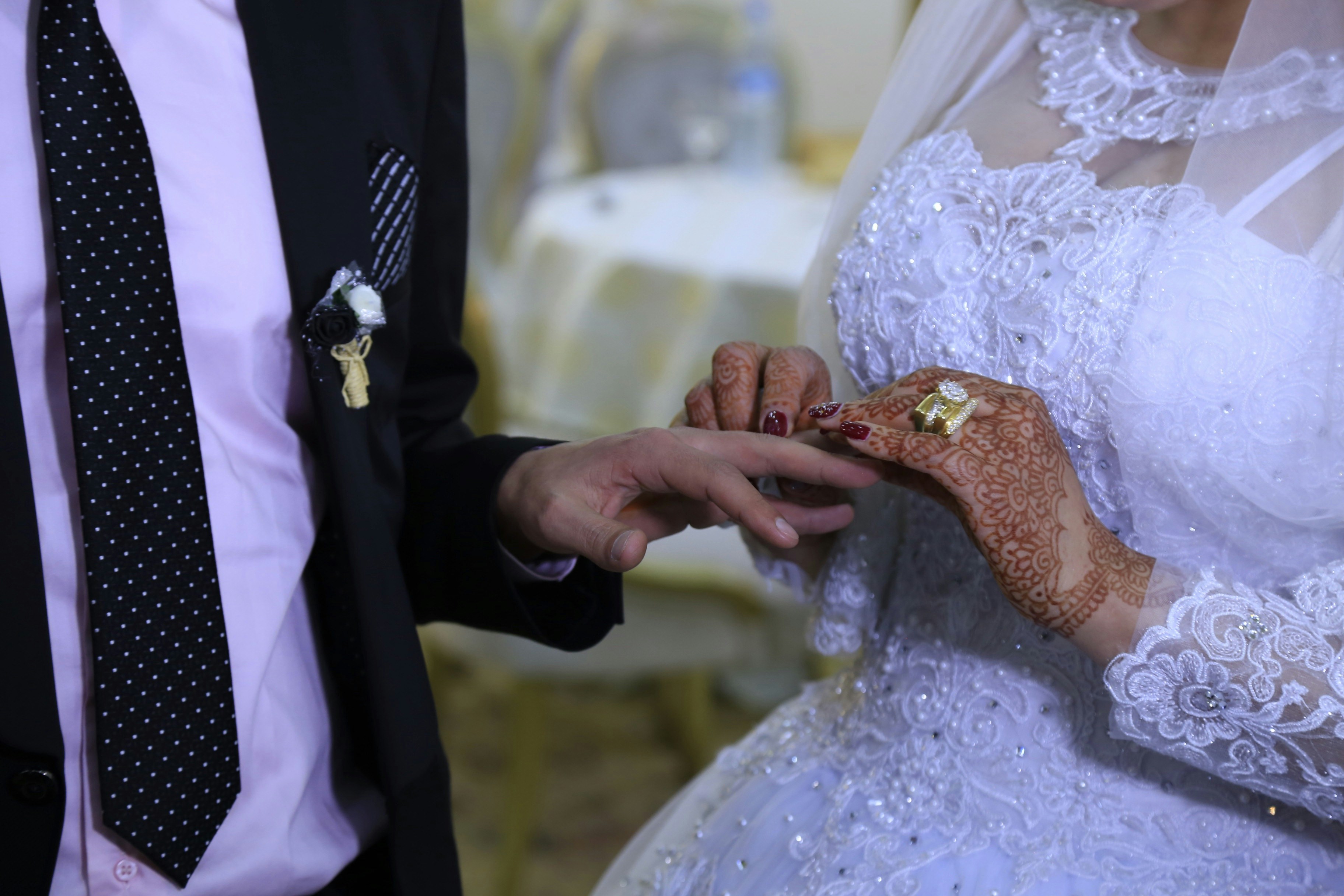 man in black suit jacket and woman in white wedding dress