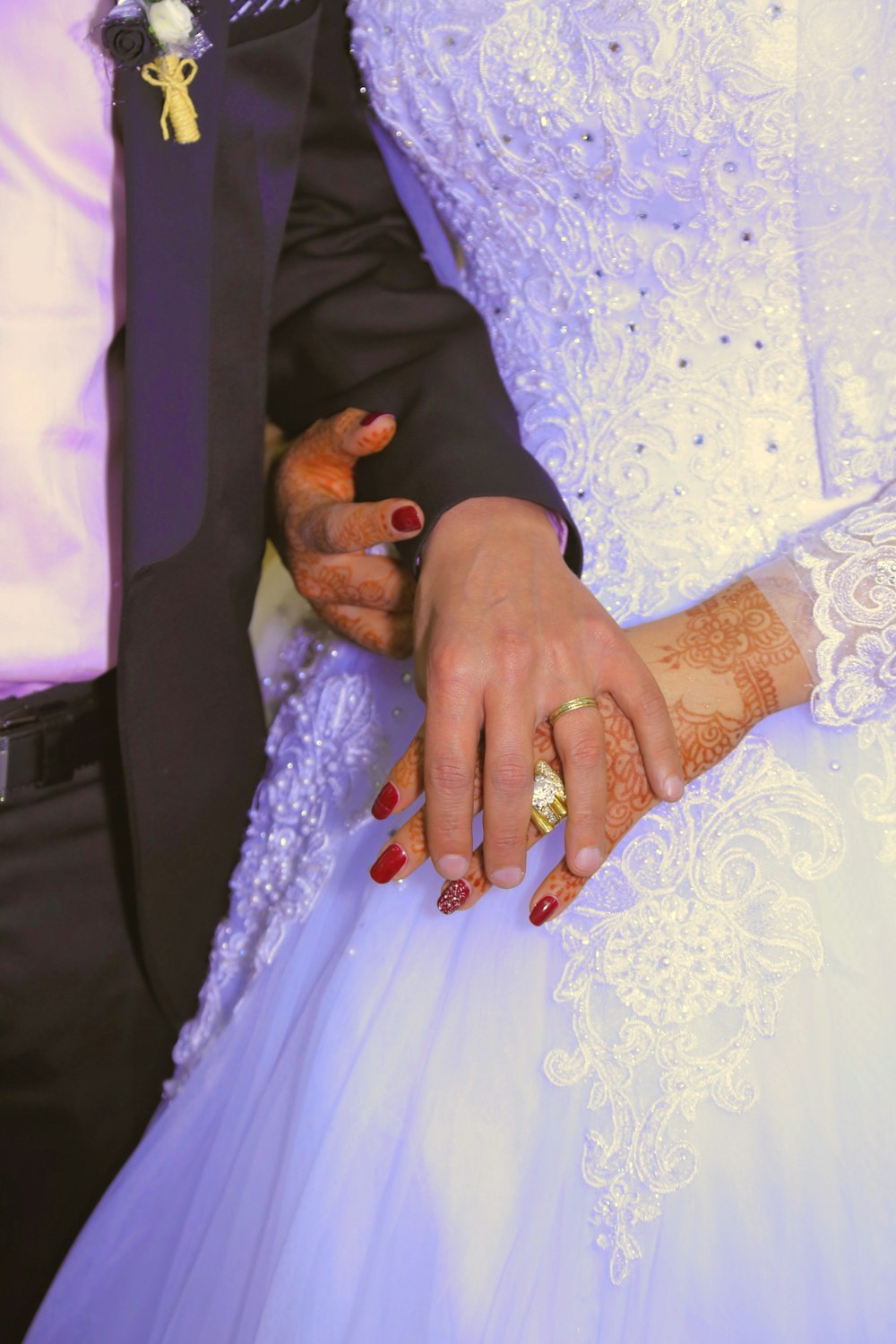 man in black suit jacket and woman in white wedding dress