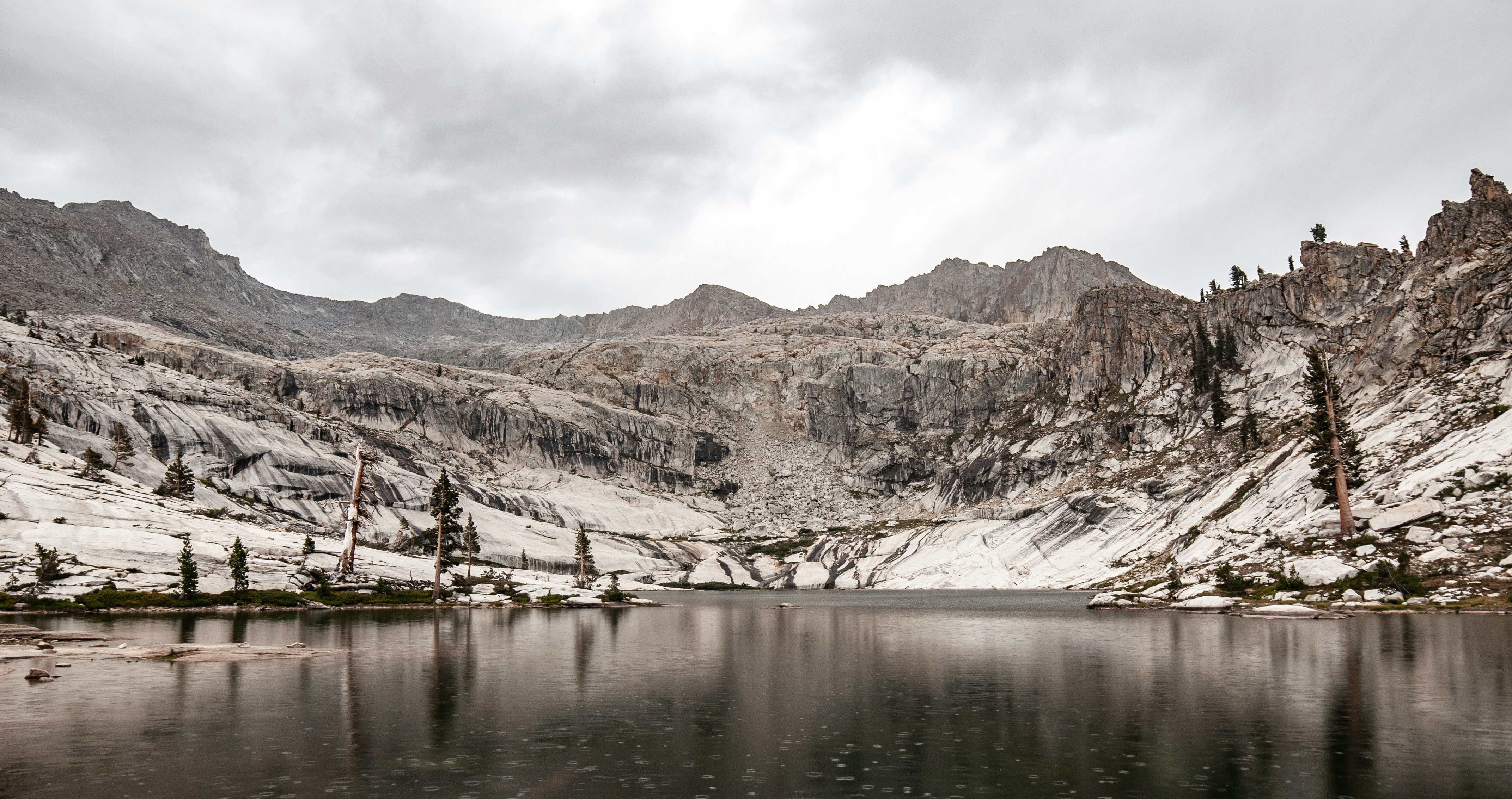 brown and white mountains near body of water during daytime