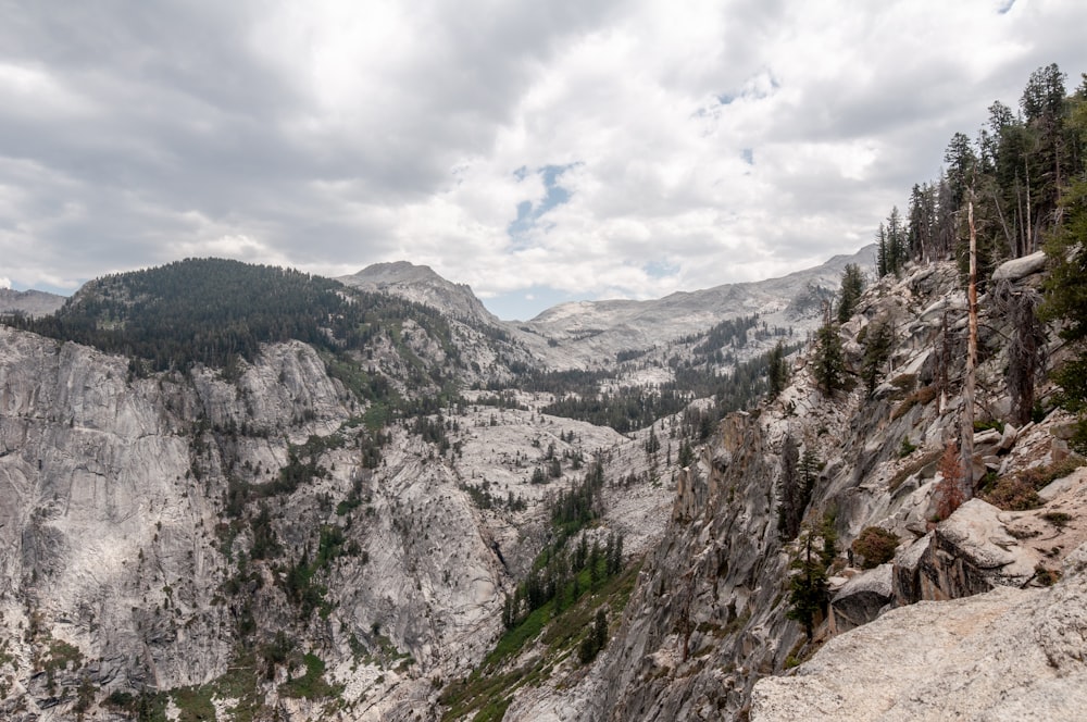 gray rocky mountain under white clouds during daytime