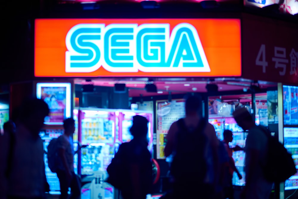 people standing near red and white open neon signage