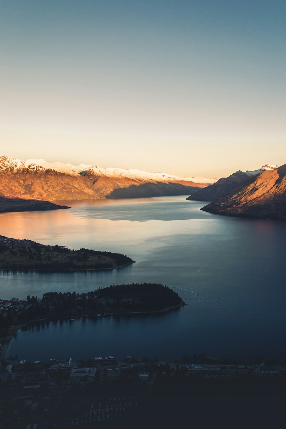 brown mountains beside body of water during daytime