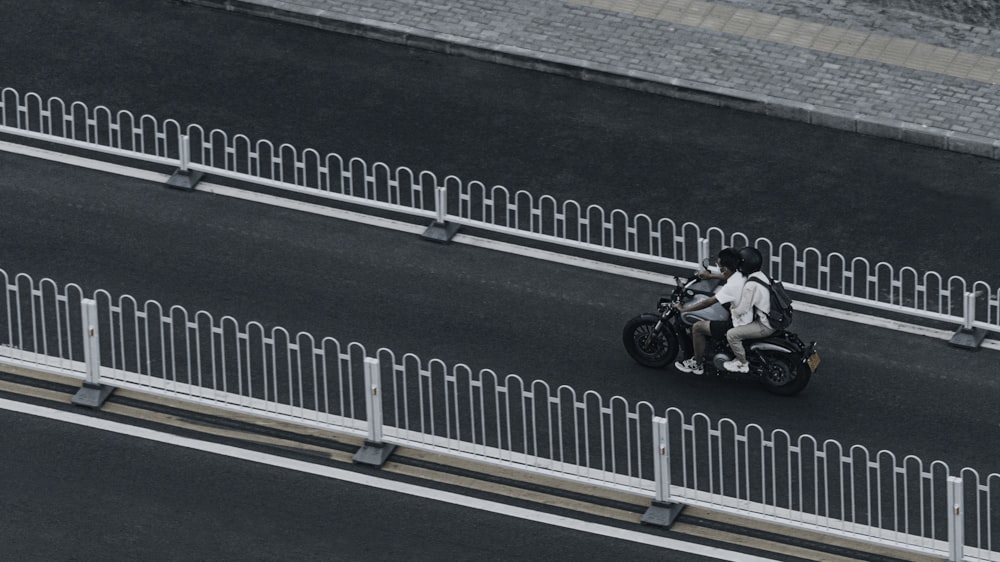 man in black jacket riding motorcycle on road during daytime