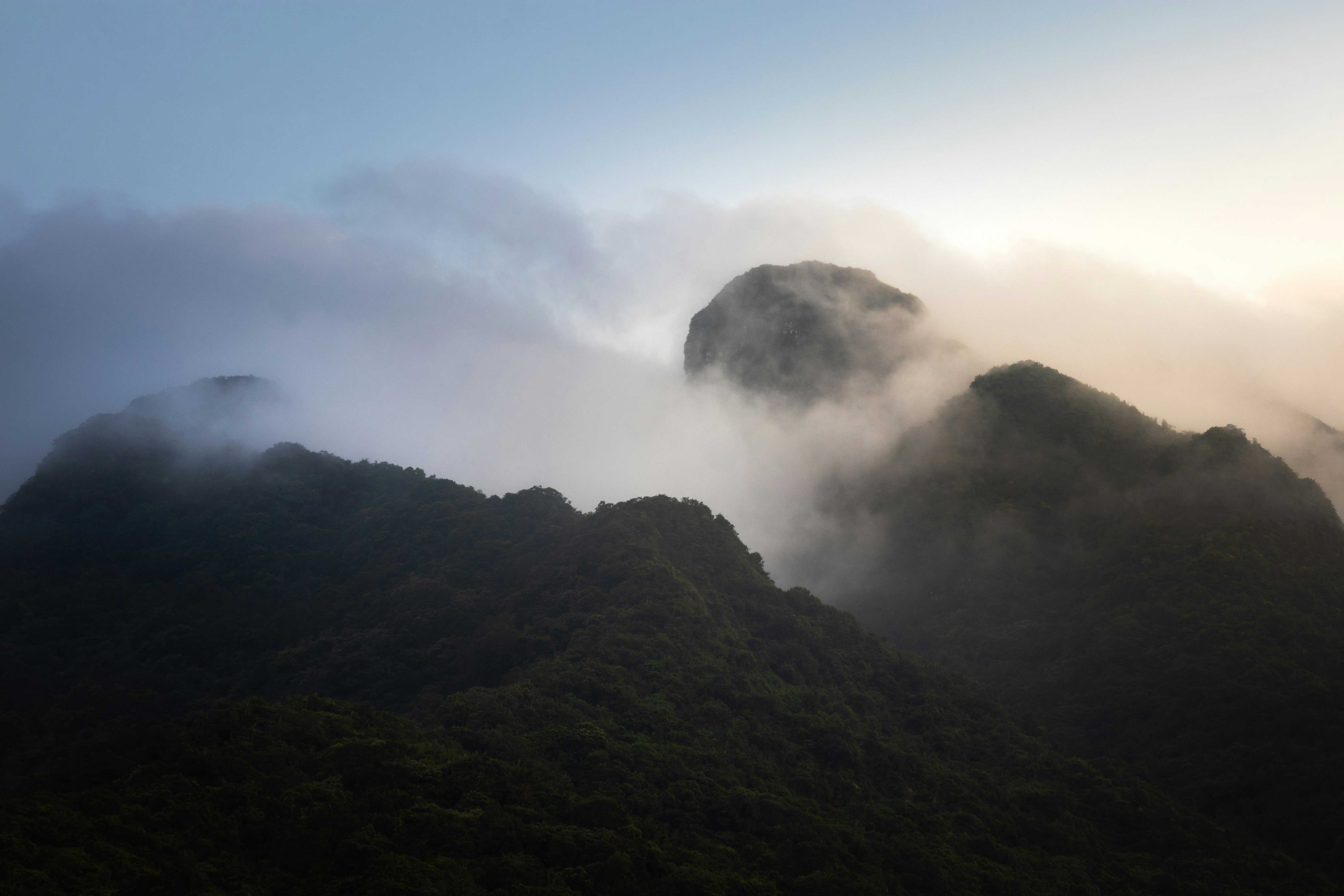 green mountain under white clouds