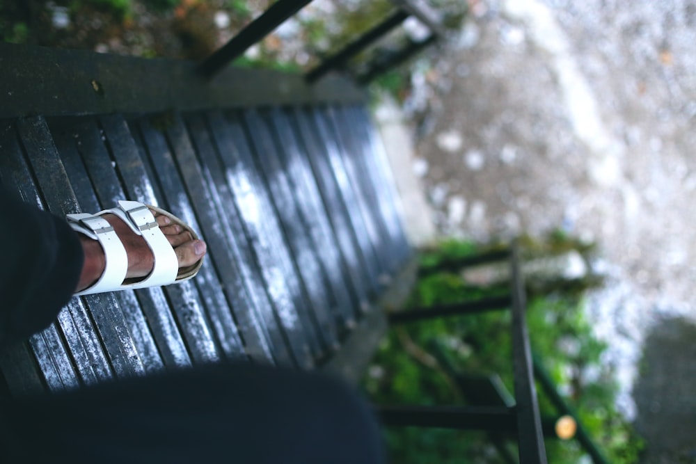 person in black and white slide sandals