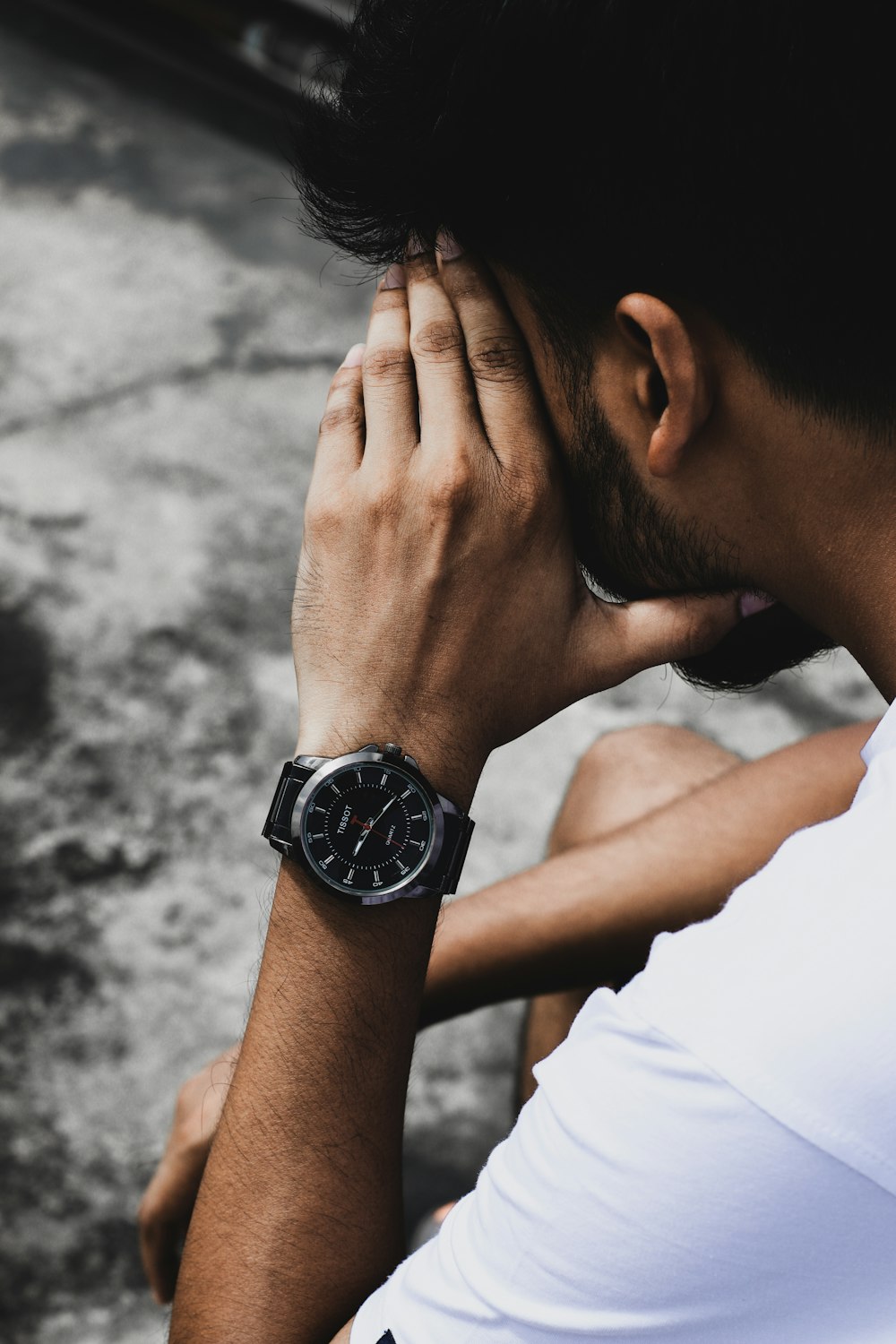 man in white shirt wearing black round analog watch