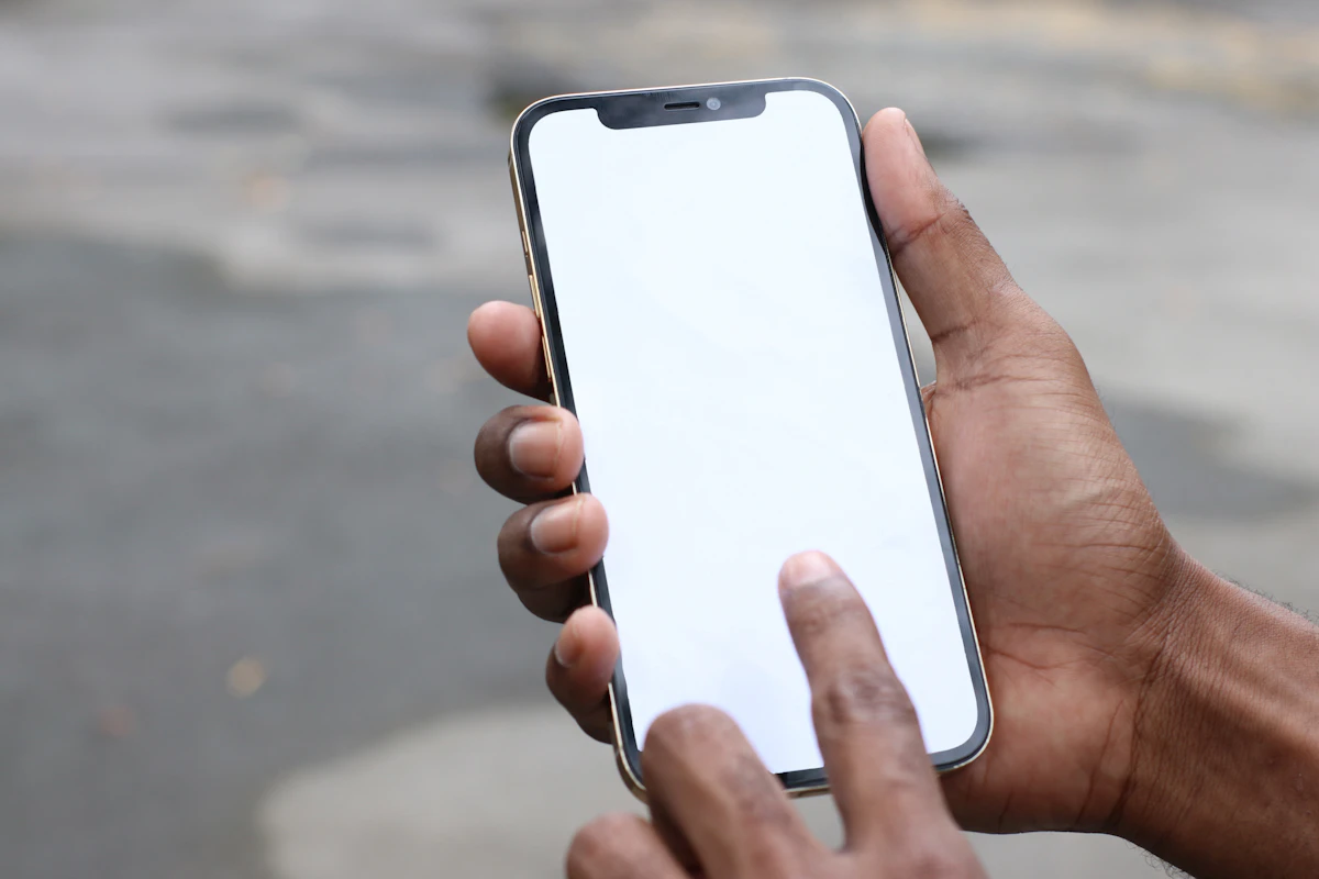 Person holding silver iphone 6 with black case