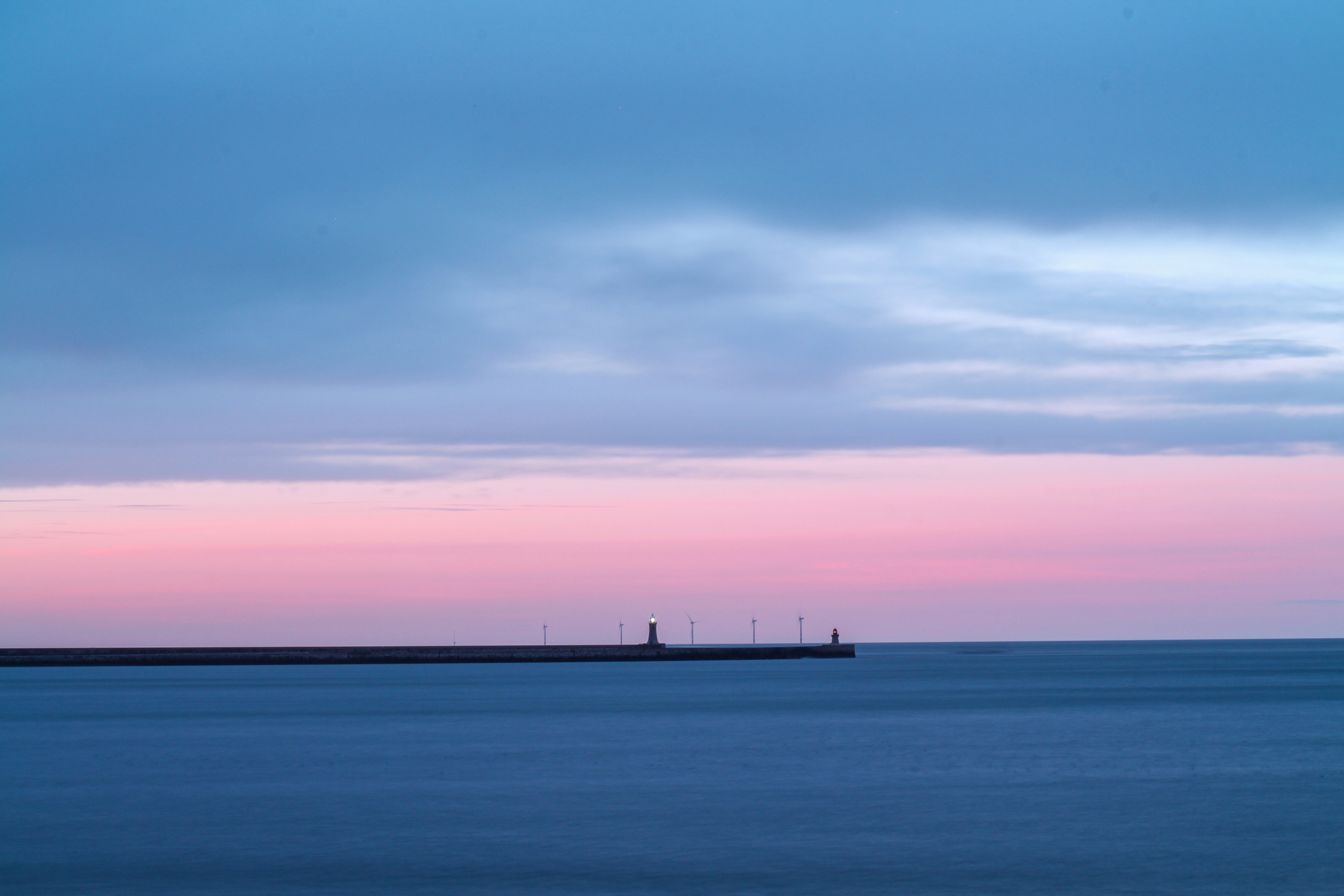 silhouette of people on sea during sunset