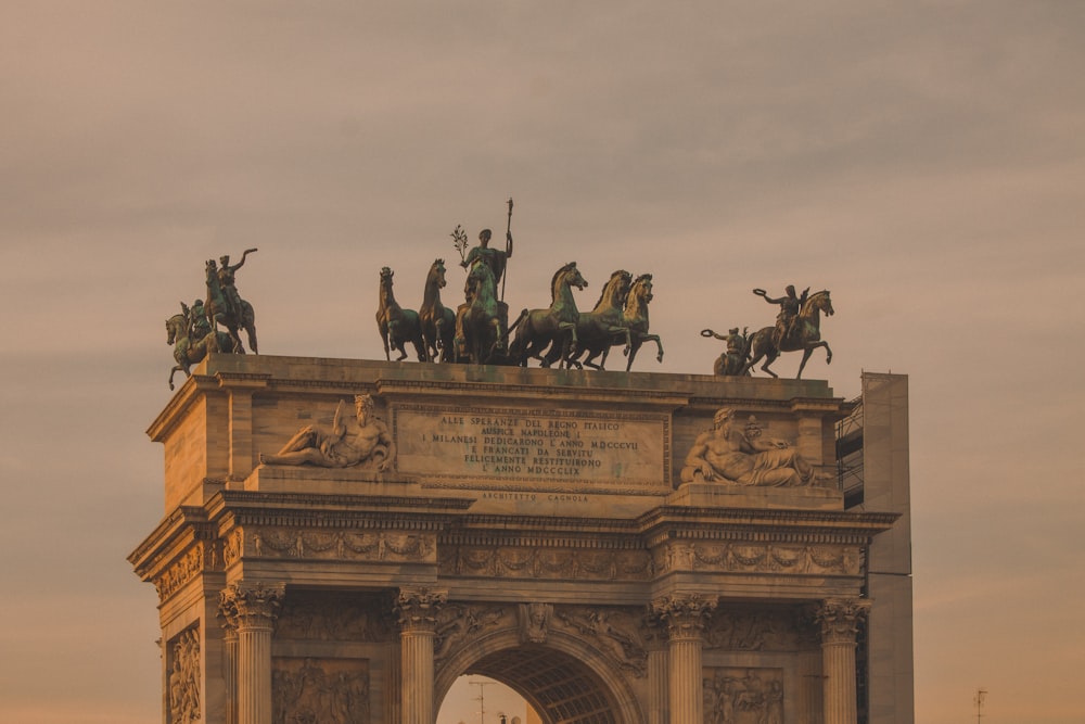 people riding horses statue during daytime