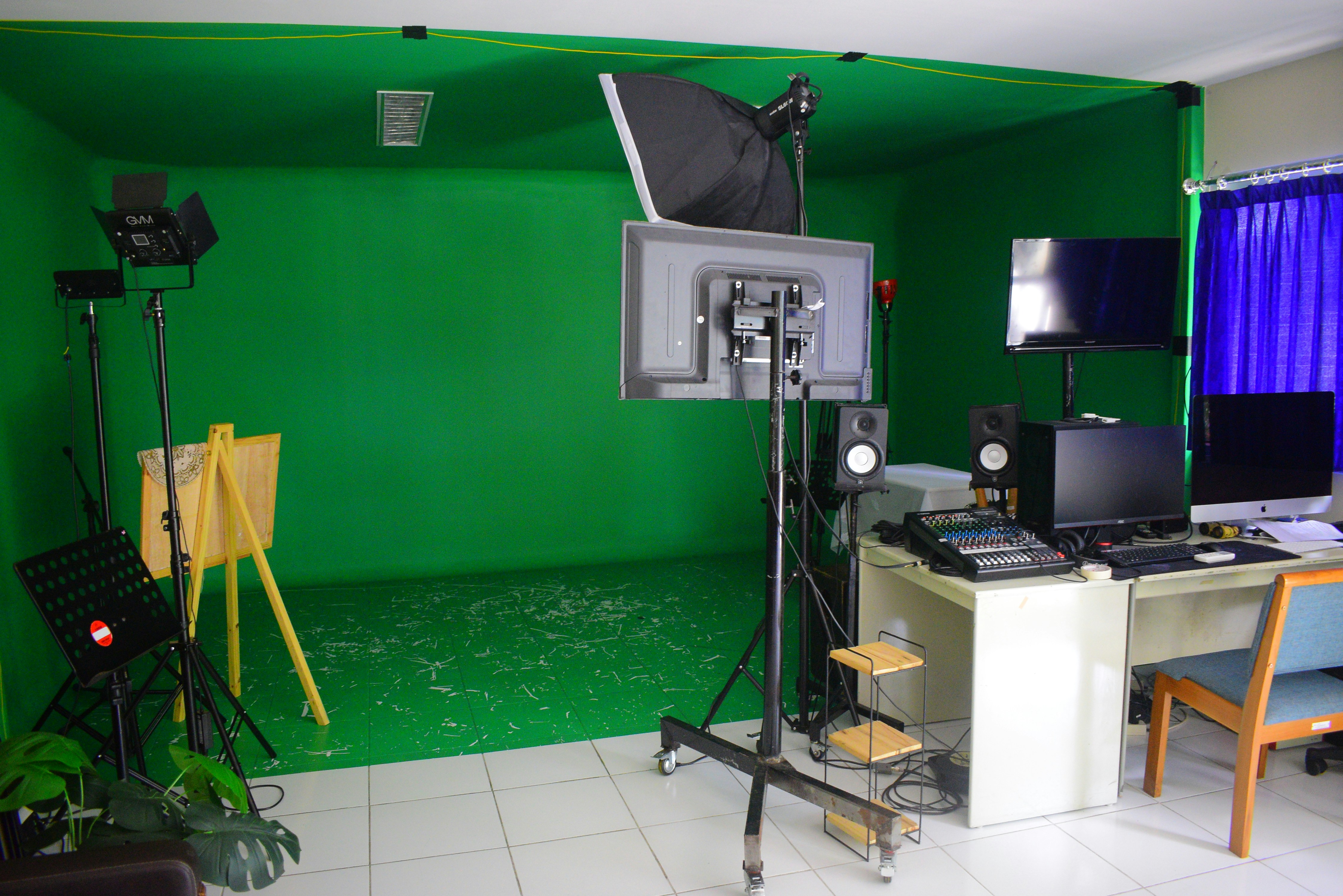 Modern video production area with green screen and professional audio setup