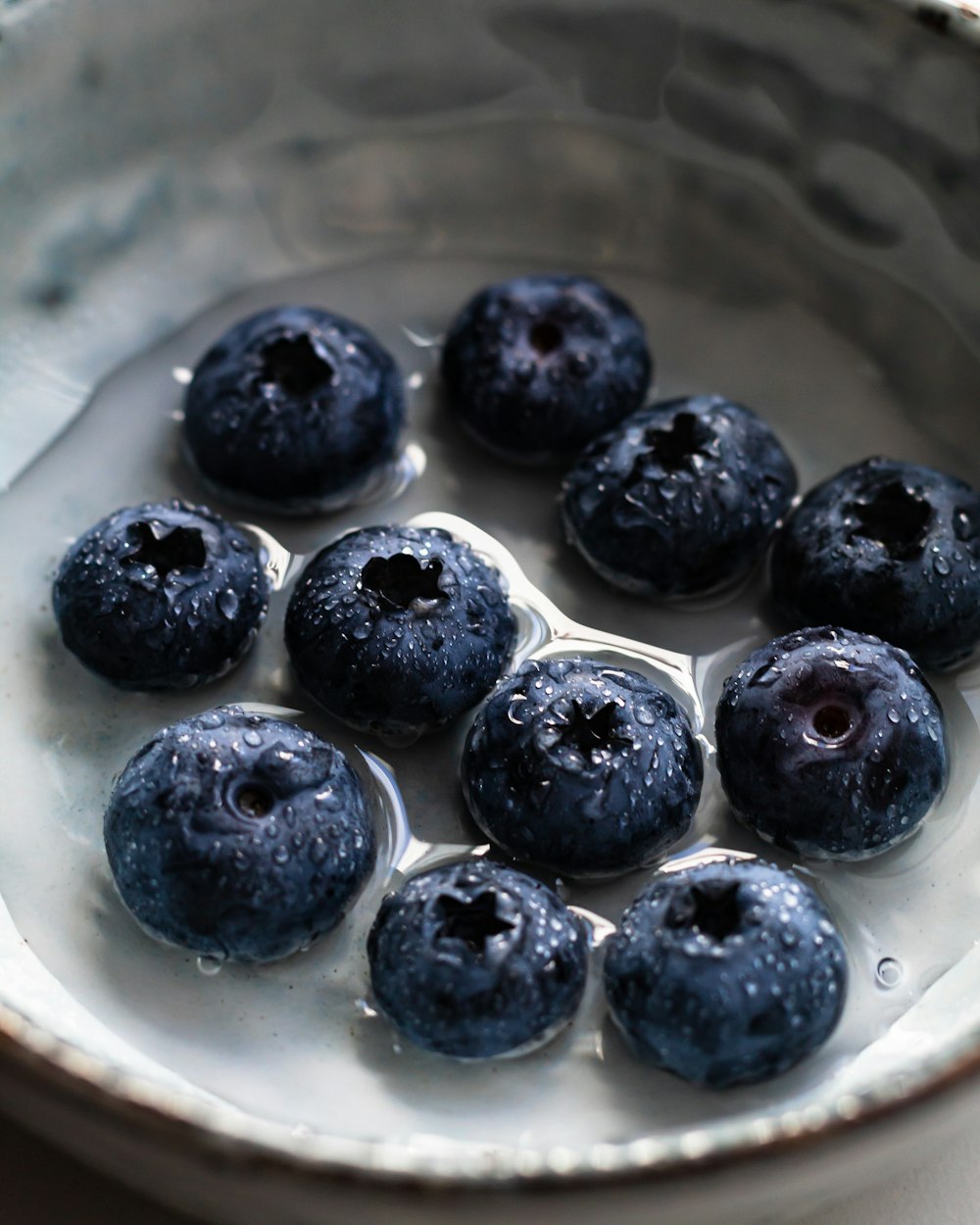 black berries on white ceramic plate