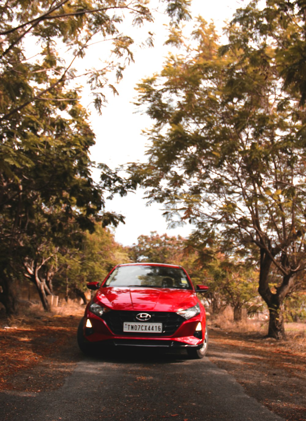 red honda car on road during daytime