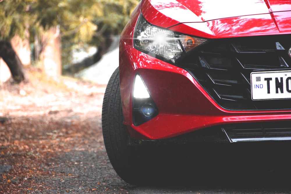 red car on gray asphalt road during daytime