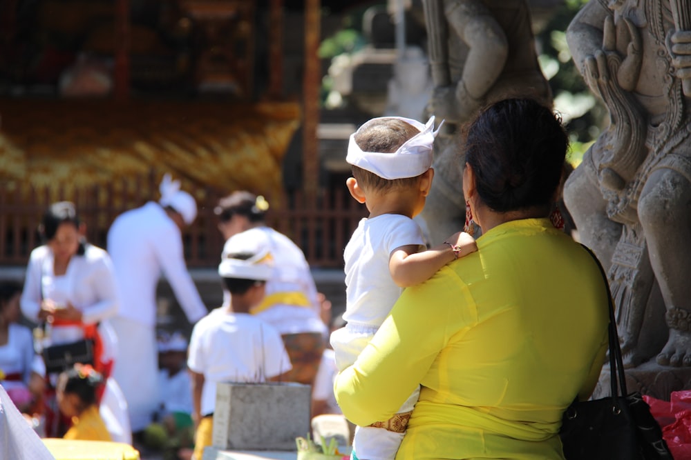 man in yellow polo shirt wearing white cap