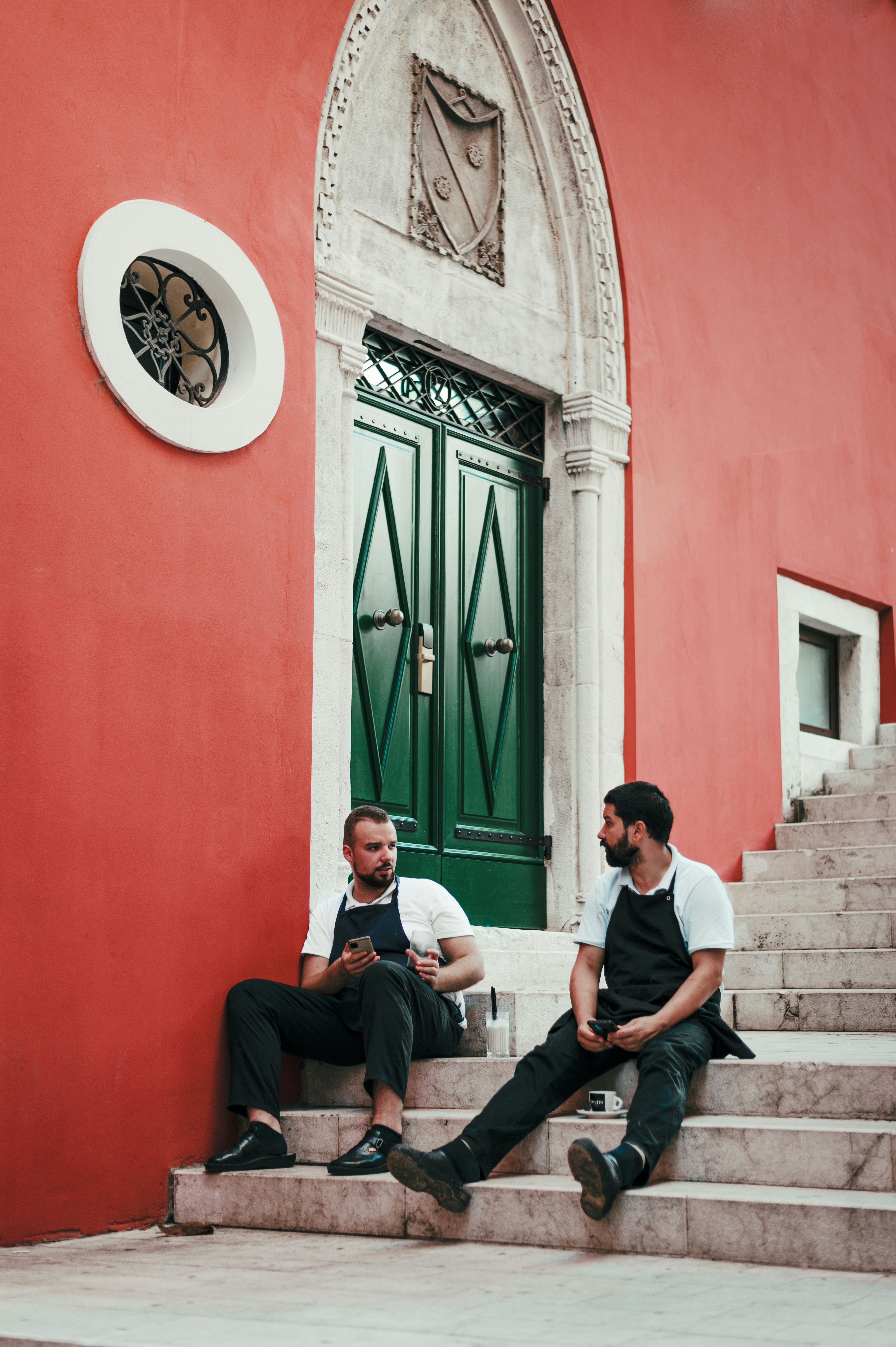 man in white dress shirt sitting on gray concrete bench