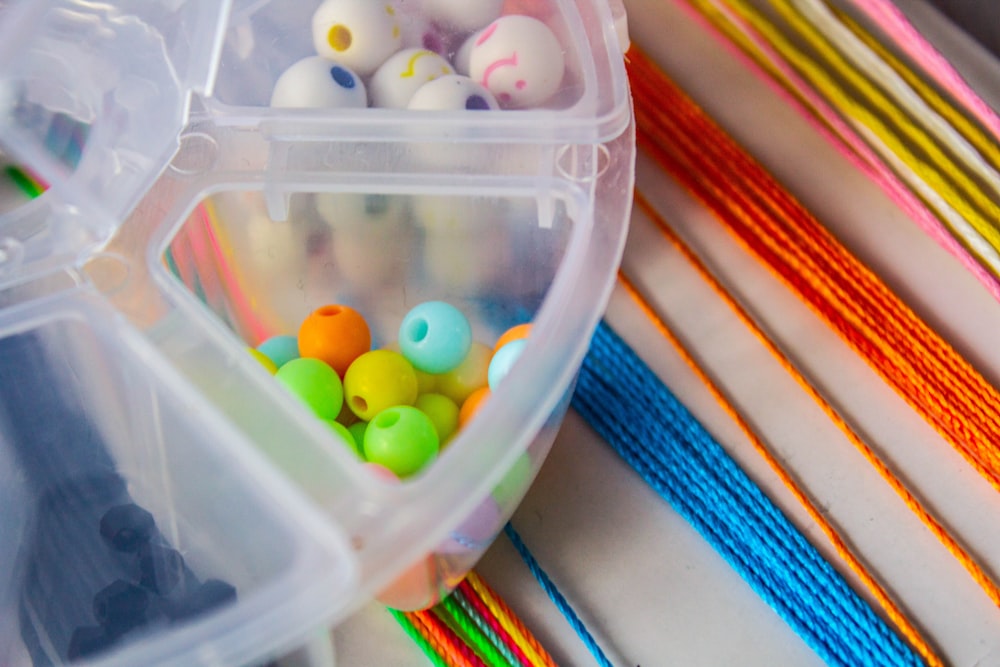 yellow and orange candies in plastic container