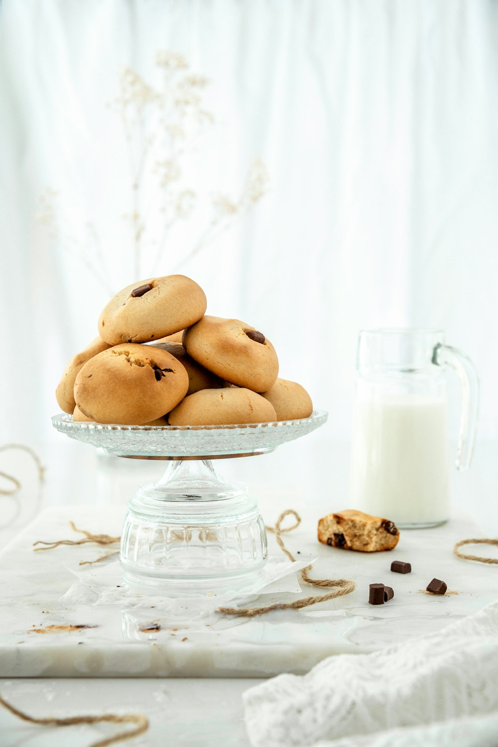 three brown cookies on white ceramic plate