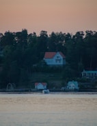 A serene waterfront property owned by Kush Holdings at sunrise.