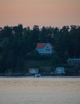 A serene waterfront property owned by Kush Holdings at sunrise.