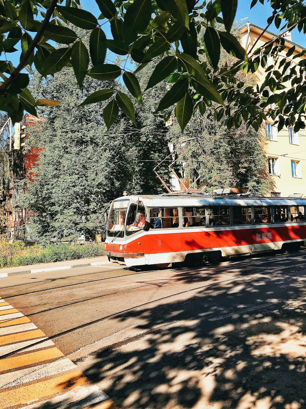 red and white tram on road during daytime