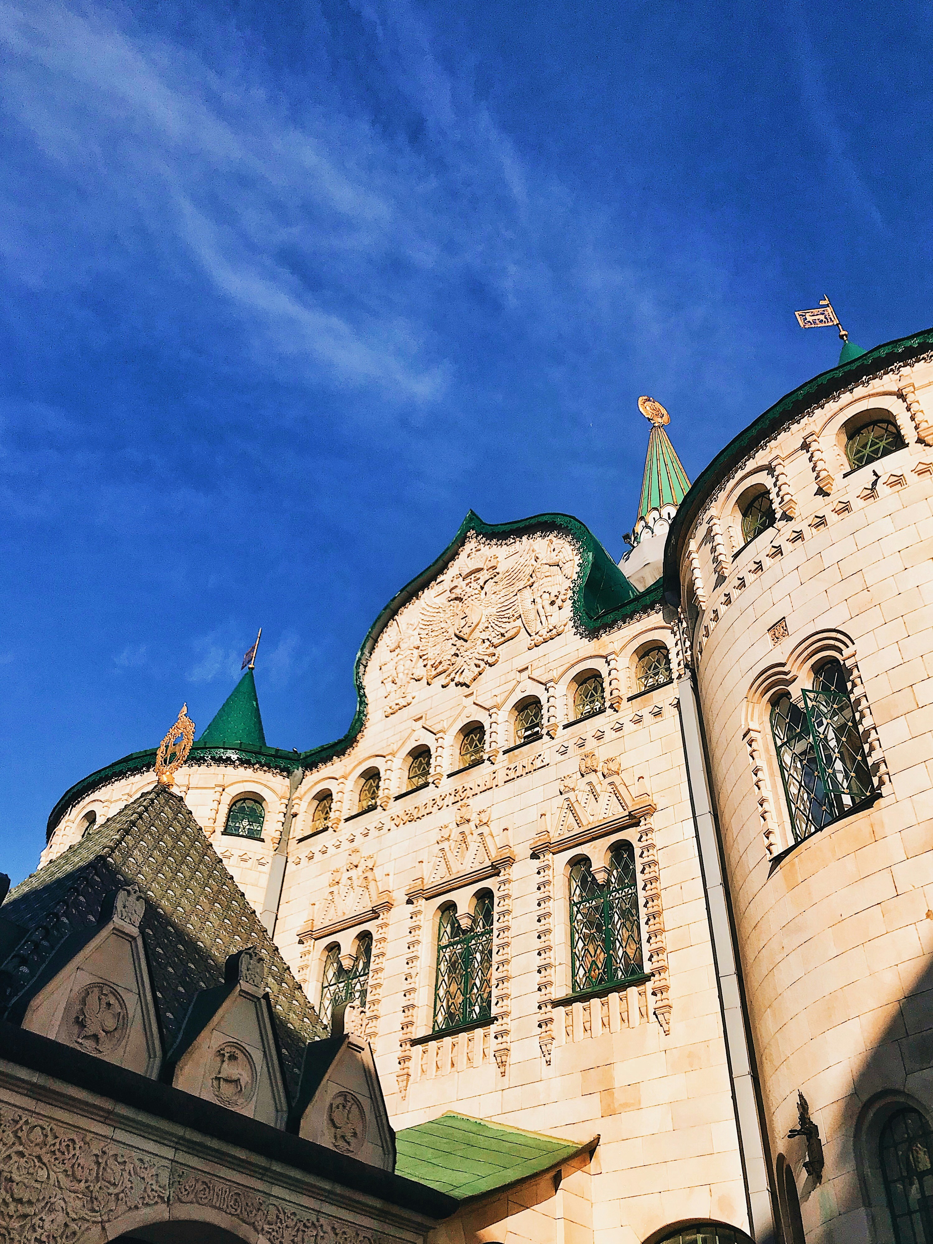 beige concrete building under blue sky during daytime