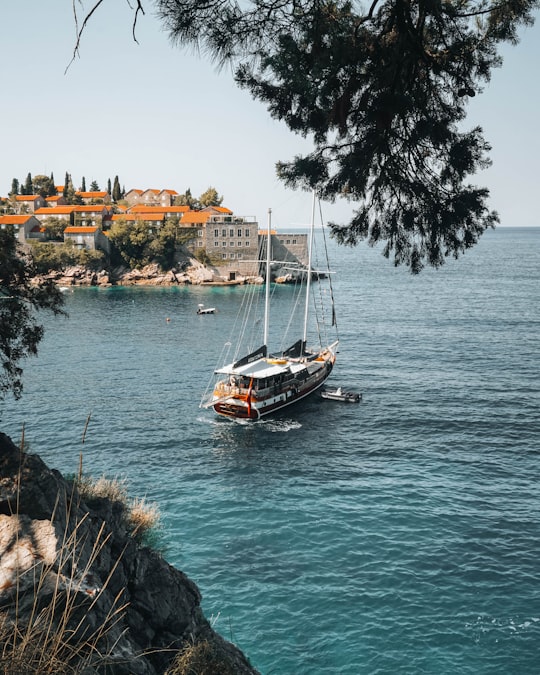 white and black boat on water during daytime in Sveti Stefan Montenegro