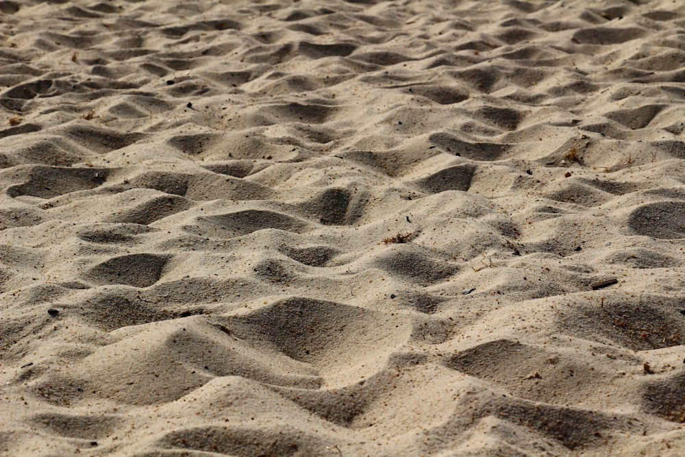 brown sand with footprints during daytime