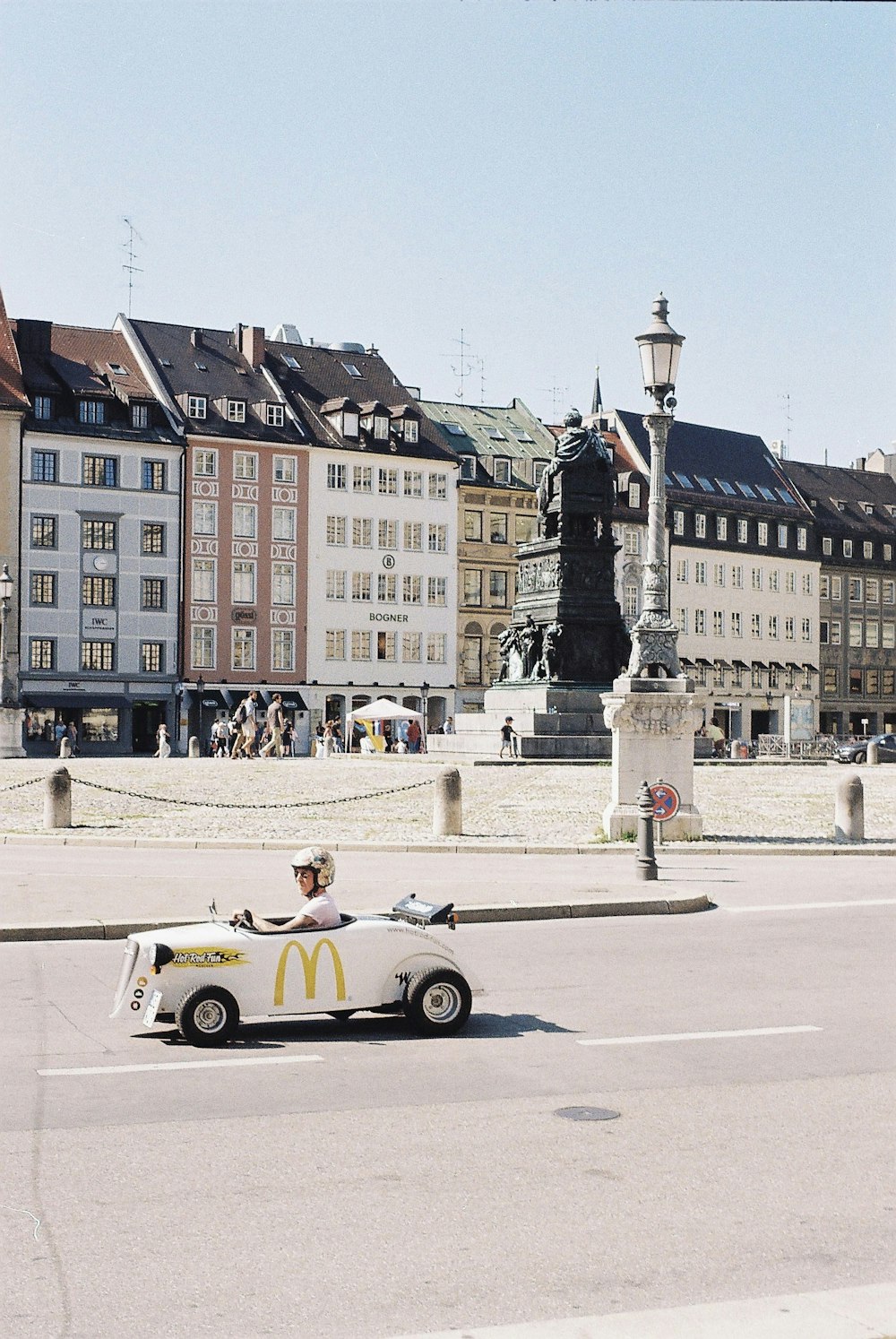 man in white shirt riding white convertible car on road during daytime