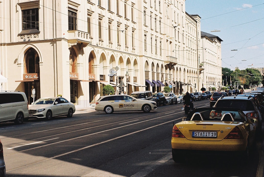 cars parked on side of road near building during daytime