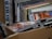 A collection of stacked CD cases inside a cardboard box, with visible album art and text on the covers. The CDs appear to be packed closely together, suggesting they are part of a larger collection.