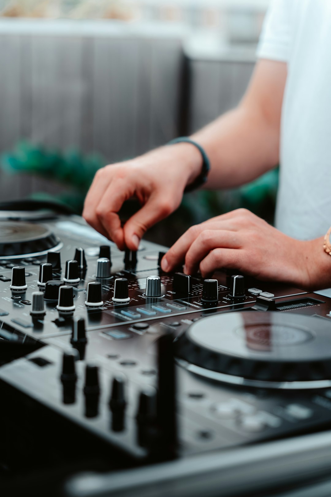 person playing black and white dj mixer