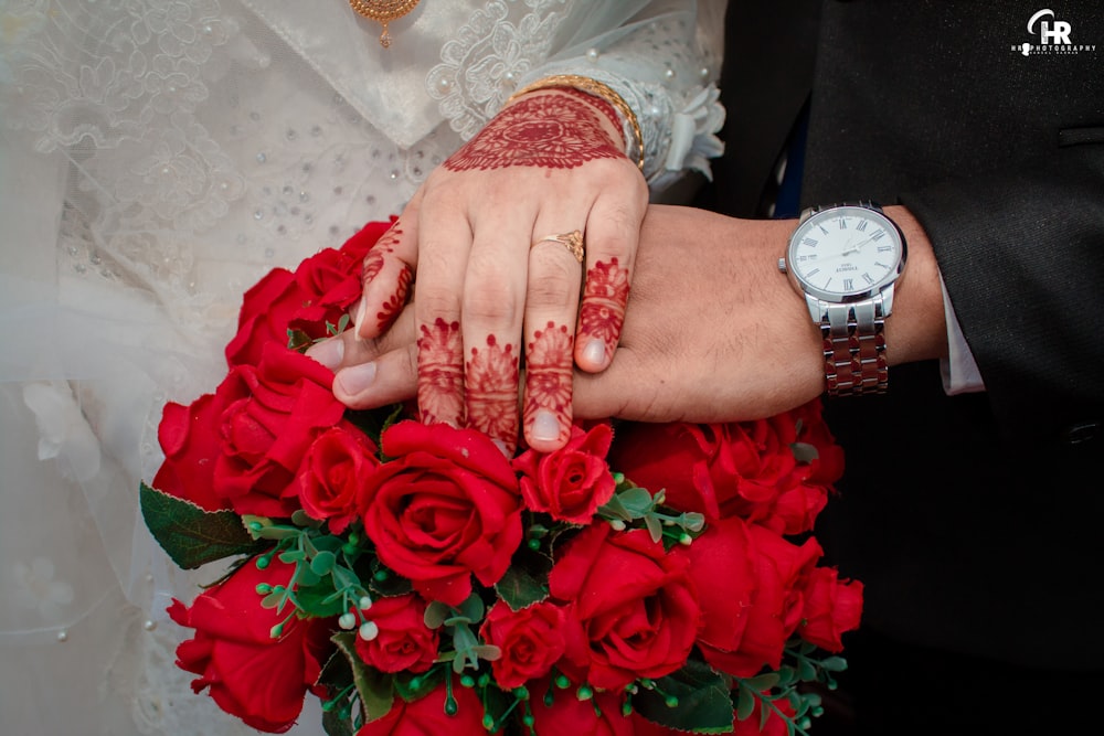 woman in white lace dress holding red rose bouquet