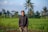 man in black jacket standing on green grass field during daytime