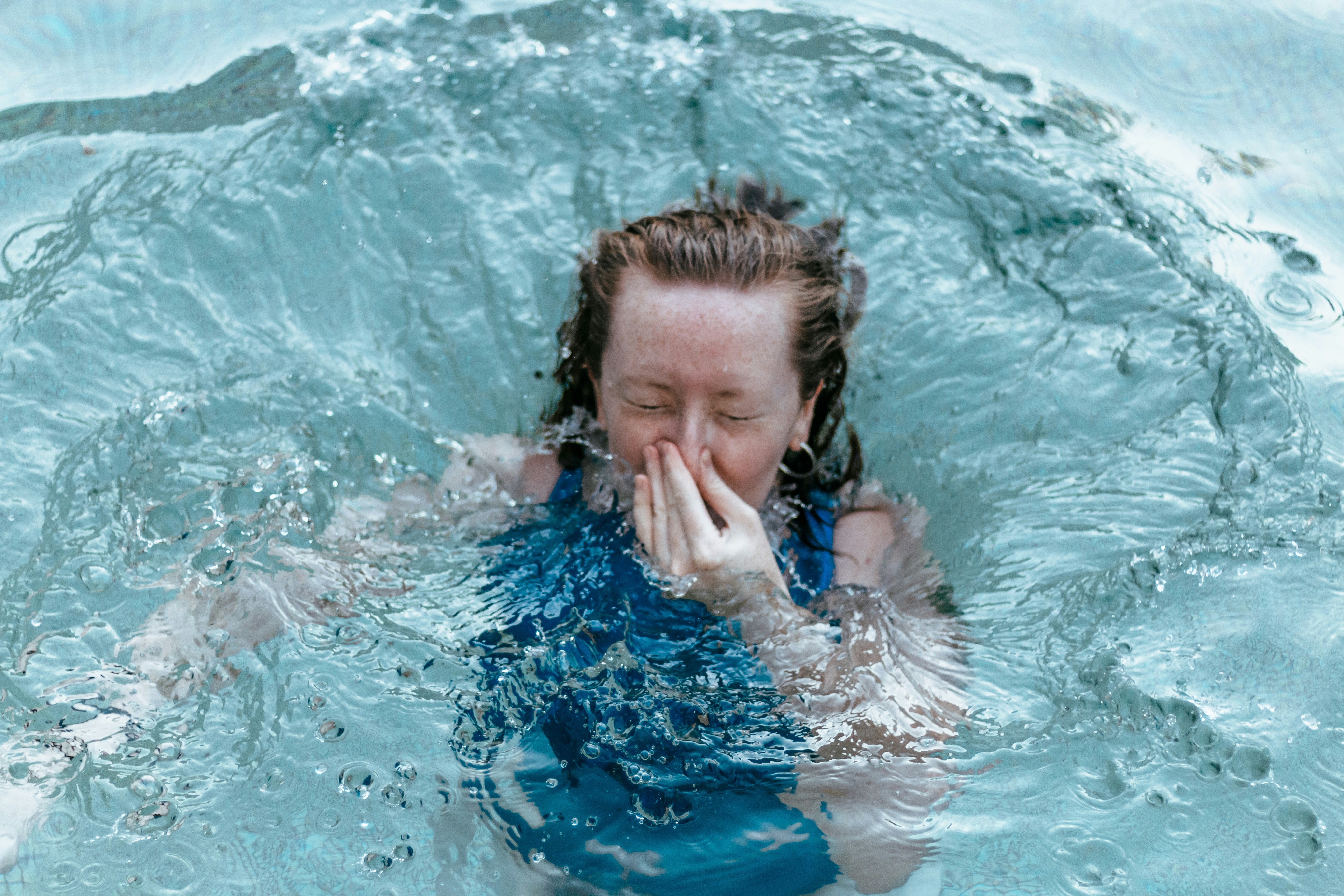 girl in blue and white swimsuit in water