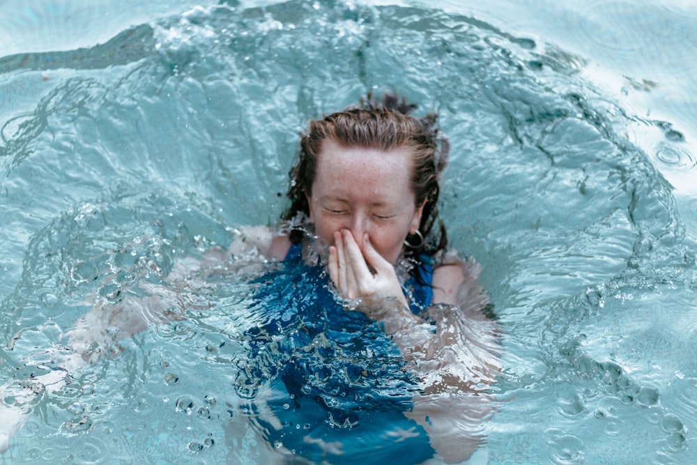 girl in blue and white swimsuit in water