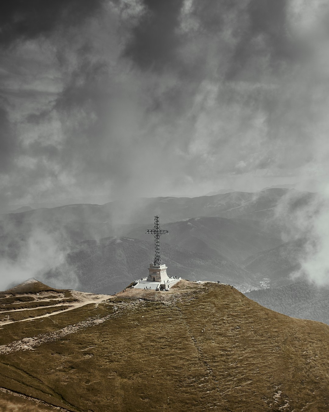 white clouds over brown mountain