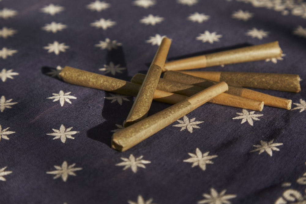 brown wooden sticks on blue and white floral textile