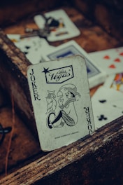 joker playing card on brown wooden table