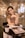 woman in brown tank top sitting by the table