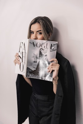 woman in black long sleeve shirt holding white printer paper