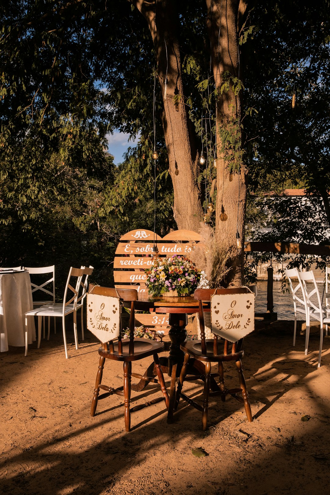 brown wooden table and chairs near trees during daytime