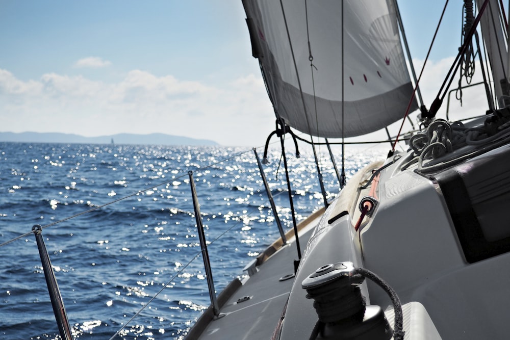 white and black boat on sea during daytime