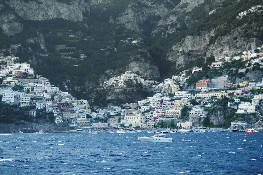 white and brown houses near body of water during daytime