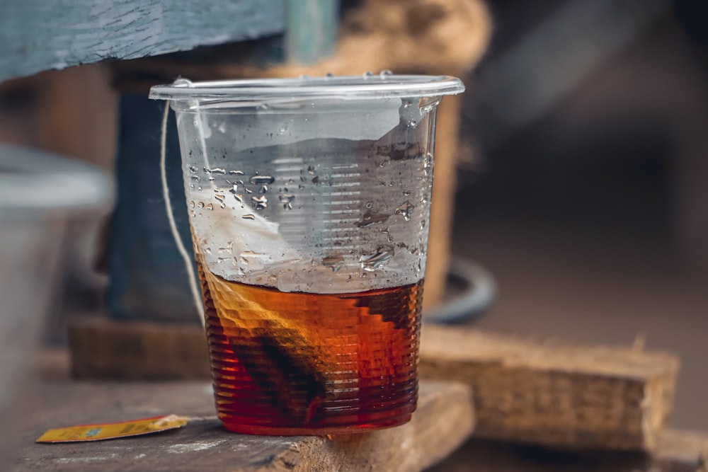 clear glass cup with brown liquid