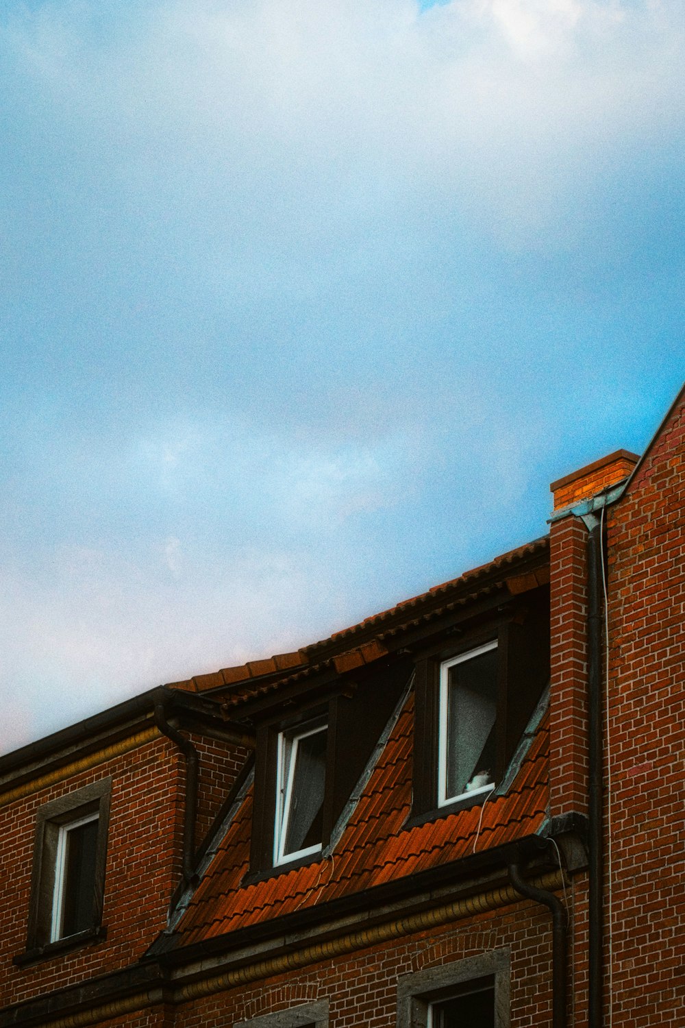 brown brick house under blue sky during daytime