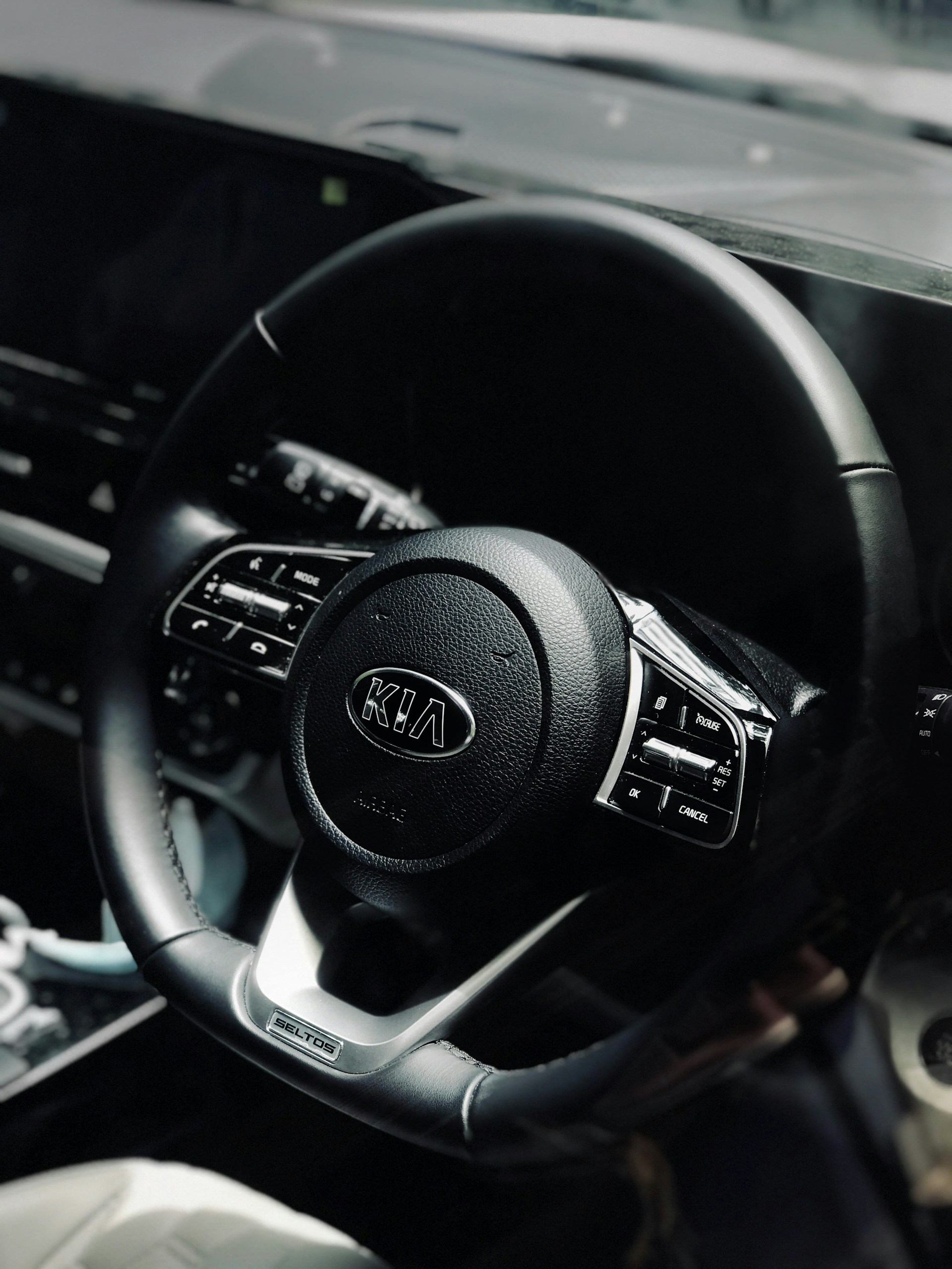 black and silver nissan steering wheel