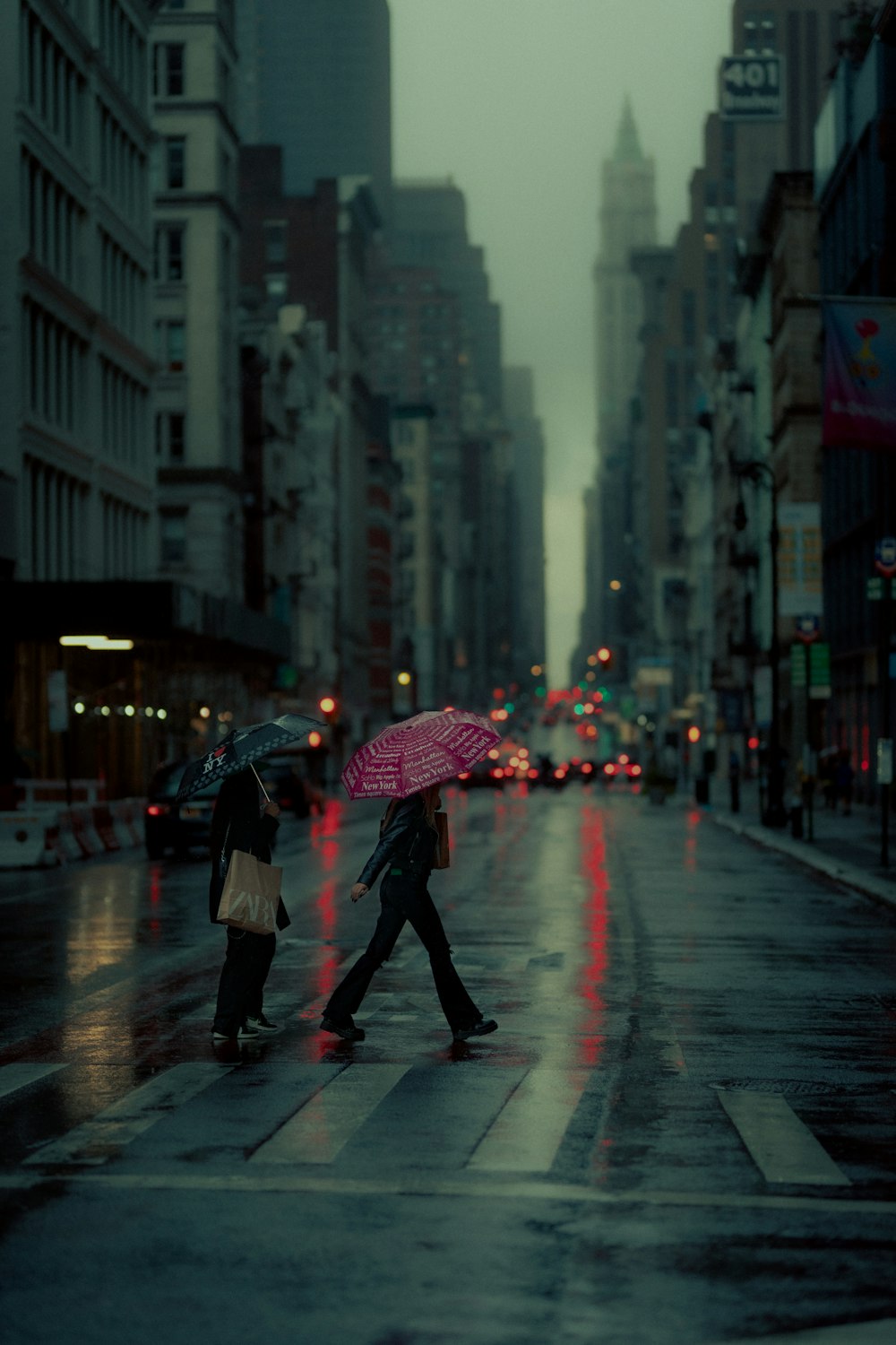 man in black jacket holding umbrella walking on street during daytime