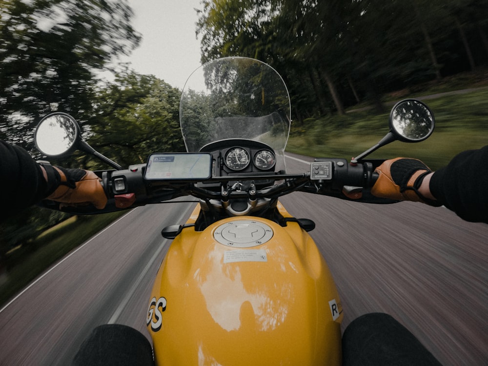 man riding motorcycle on road during daytime