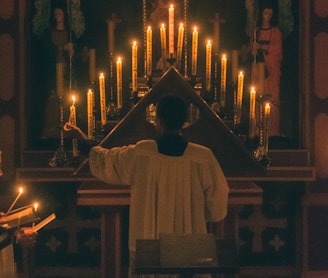 man in white thobe standing in front of church