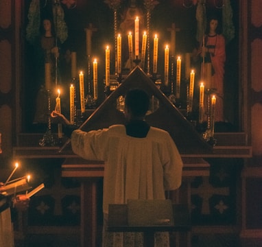 man in white thobe standing in front of church